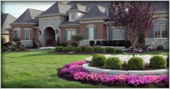 Brick house with a landscaped yard.