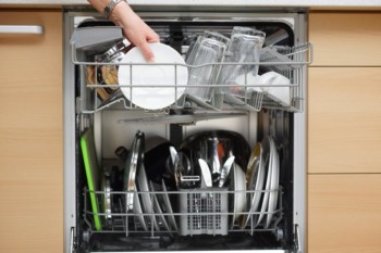 Dishes and utensils in a dishwasher.